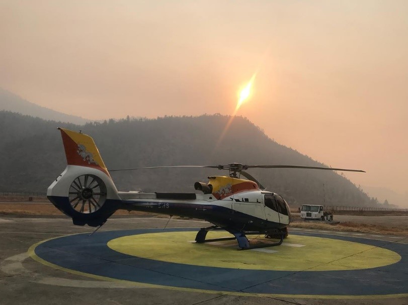 Helicopter on helipad at sunset
